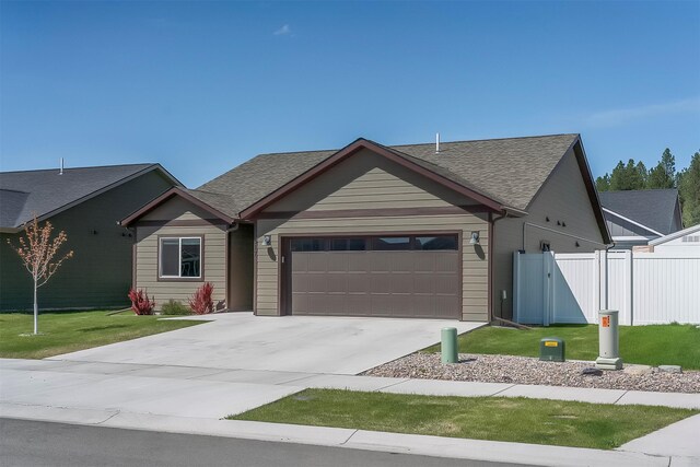 517 Raven Ln, Kalispell, MT 59901 - ranch-style home featuring an attached garage, driveway, and a shingled roof