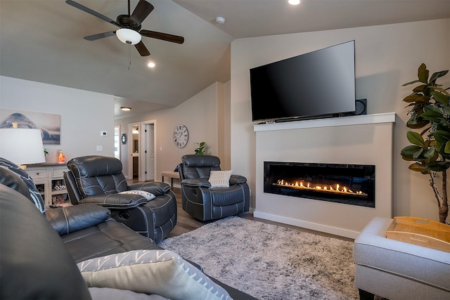 517 Raven Ln, Kalispell, MT 59901 - living room with lofted ceiling, a glass covered fireplace, wood finished floors, ceiling fan, and recessed lighting
