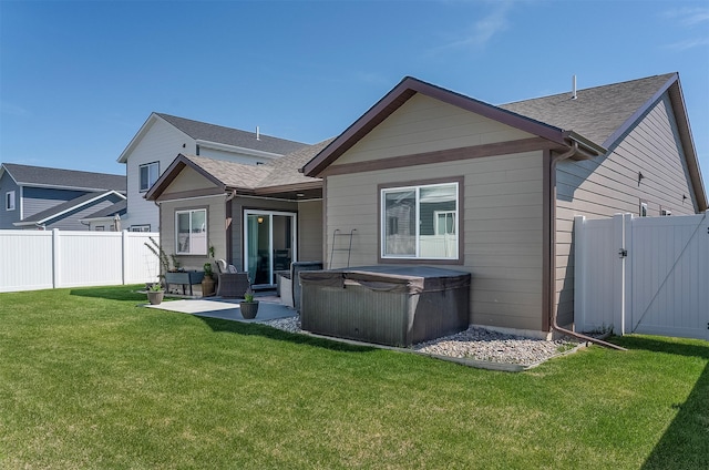 517 Raven Ln, Kalispell, MT 59901 - back of property featuring a hot tub, roof with shingles, a patio, and an outdoor living space