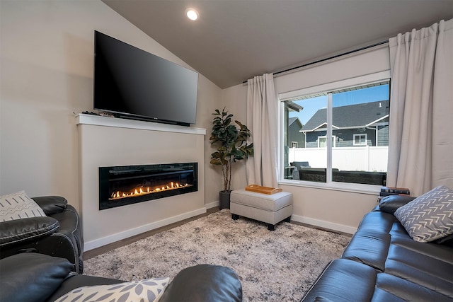 517 Raven Ln, Kalispell, MT 59901 - living room with a glass covered fireplace, wood finished floors, lofted ceiling, and recessed lighting