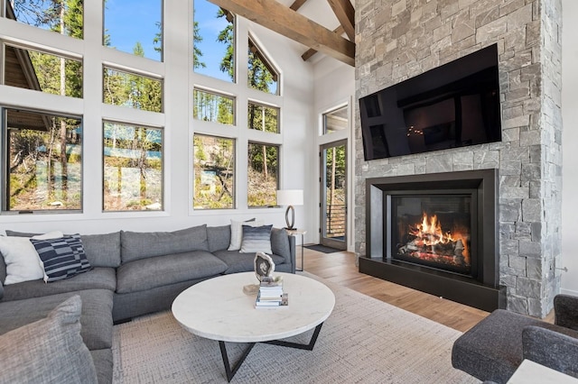145 Elk Highlands Dr, Whitefish, MT 59937 - living room featuring wood finished floors, a fireplace, and high vaulted ceiling