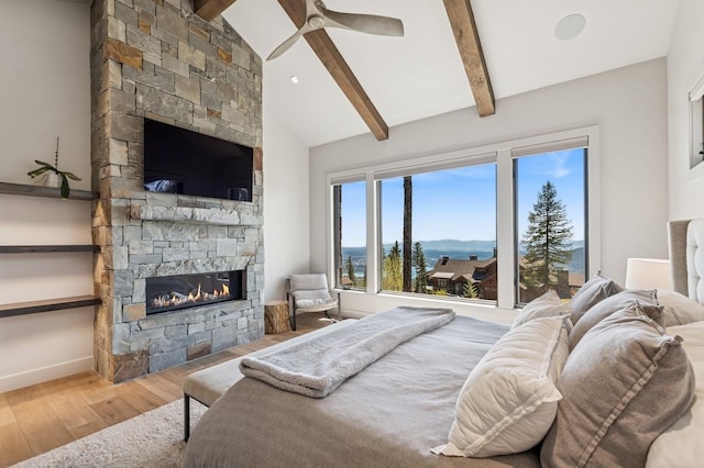 145 Elk Highlands Dr, Whitefish, MT 59937 - bedroom featuring a stone fireplace, wood finished floors, and baseboards
