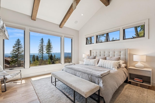145 Elk Highlands Dr, Whitefish, MT 59937 - bedroom featuring beam ceiling, wood finished floors, and high vaulted ceiling
