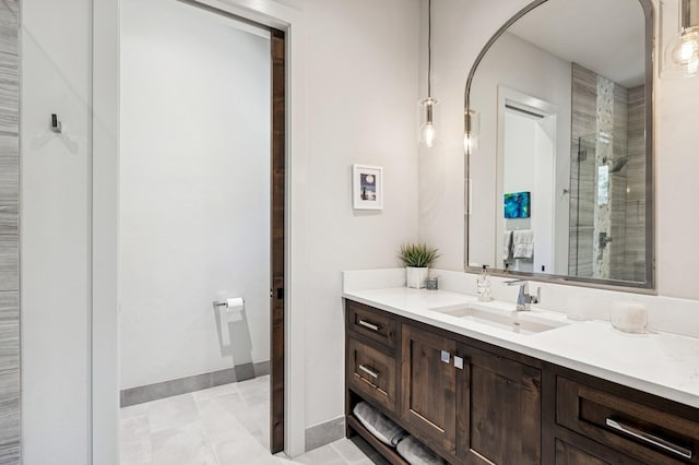 145 Elk Highlands Dr, Whitefish, MT 59937 - bathroom featuring tiled shower, vanity, baseboards, and tile patterned floors