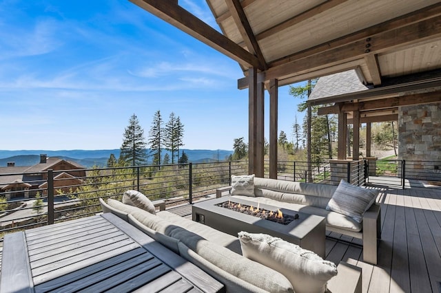 145 Elk Highlands Dr, Whitefish, MT 59937 - deck featuring a mountain view and an outdoor living space with a fire pit
