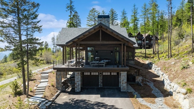 145 Elk Highlands Dr, Whitefish, MT 59937 - view of community featuring an attached garage, driveway, and stairway