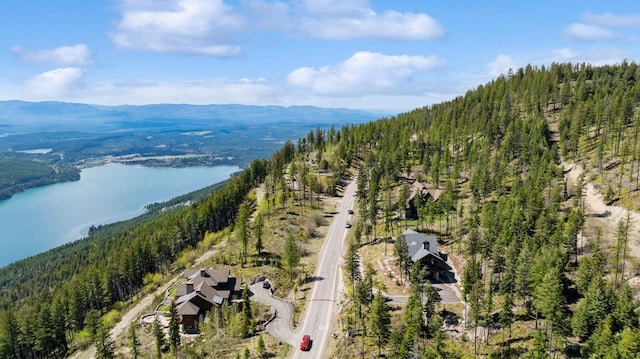 145 Elk Highlands Dr, Whitefish, MT 59937 - drone / aerial view of a heavily wooded area and a water and mountain view