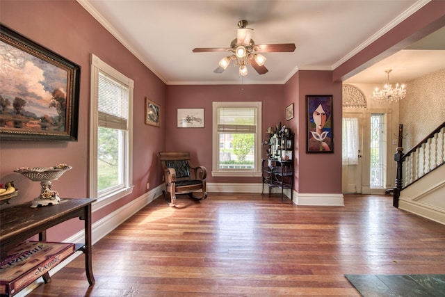 living area featuring plenty of natural light, hardwood / wood-style floors, stairway, and ornamental molding