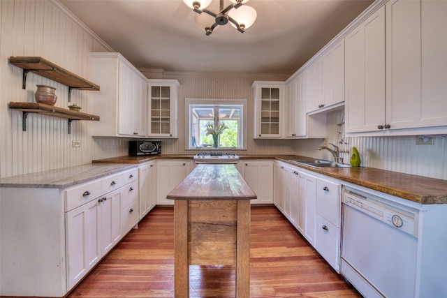 kitchen with dishwasher, a sink, white cabinets, light wood-type flooring, and open shelves