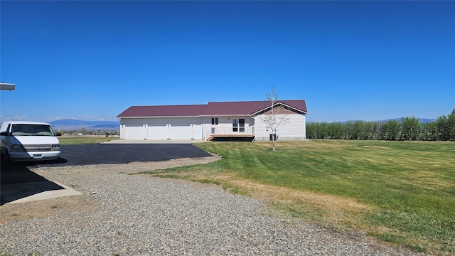 2315 Cattle Dr, East Helena, MT 59635 - ranch-style home featuring asphalt driveway, a front yard, metal roof, and an attached garage