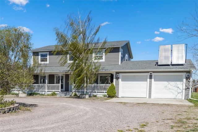 31 Aspen Ct, Kalispell, MT 59901 - view of front of home featuring dirt driveway, an attached garage, covered porch, and roof with shingles