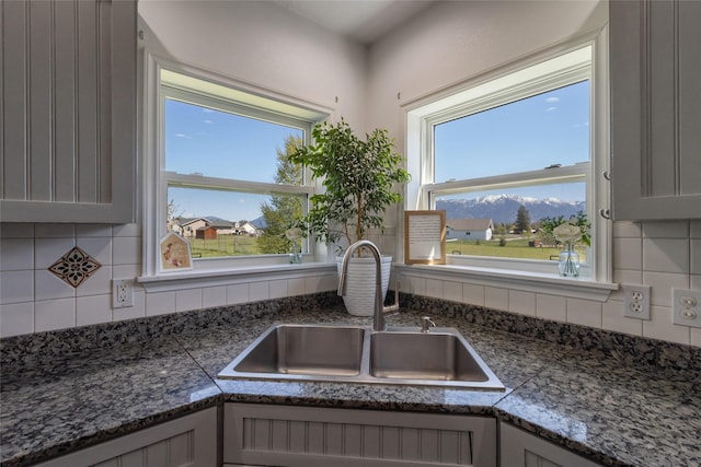 31 Aspen Ct, Kalispell, MT 59901 - kitchen view of a sink, backsplash, and gray cabinetry