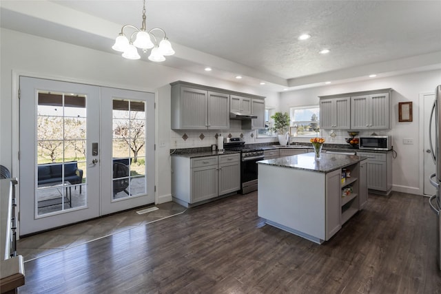 31 Aspen Ct, Kalispell, MT 59901 - kitchen featuring appliances with stainless steel finishes, gray cabinetry, french doors, open shelves, and a chandelier