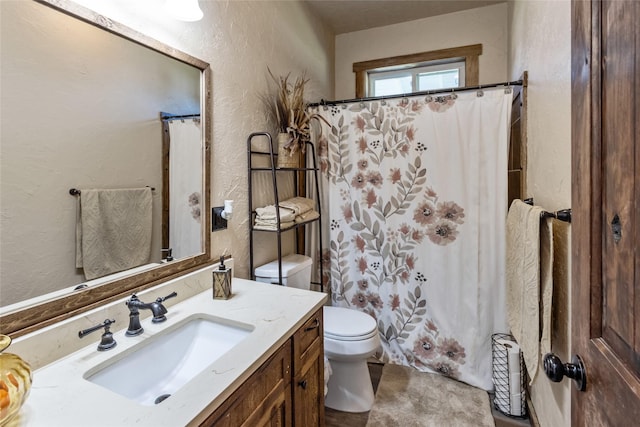 31 Aspen Ct, Kalispell, MT 59901 - bathroom featuring a textured wall, toilet, vanity, and a shower with shower curtain