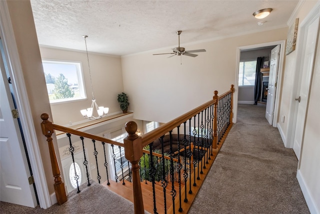 31 Aspen Ct, Kalispell, MT 59901 - stairs featuring a chandelier, carpet floors, baseboards, crown molding, and ceiling fan