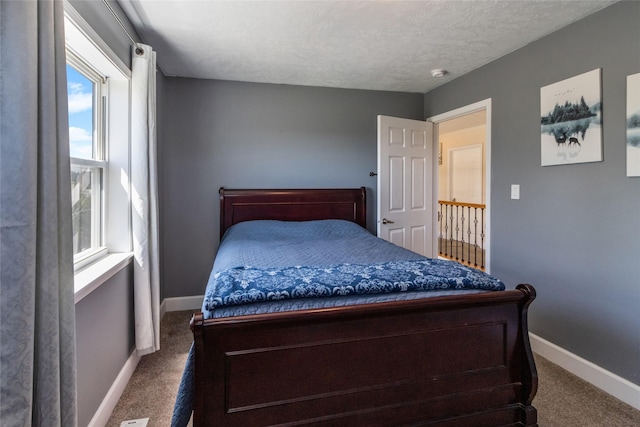 31 Aspen Ct, Kalispell, MT 59901 - carpeted bedroom with multiple windows, baseboards, and a textured ceiling