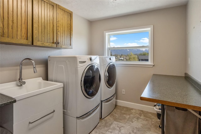 31 Aspen Ct, Kalispell, MT 59901 - washroom featuring washer and dryer, cabinet space, and baseboards