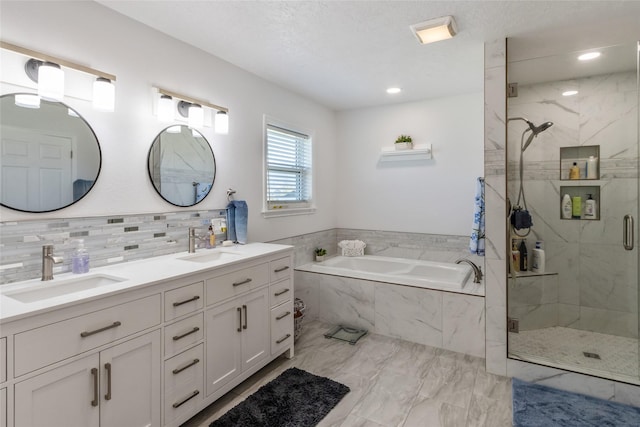 31 Aspen Ct, Kalispell, MT 59901 - full bath with a marble finish shower, a garden tub, decorative backsplash, double vanity, and marble look tiles
