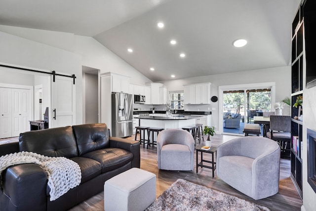 286 Ordway Dr, Florence, MT 59833 - living area featuring a barn door, dark wood-style floors, high vaulted ceiling, and recessed lighting