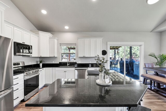 286 Ordway Dr, Florence, MT 59833 - kitchen with stainless steel appliances, a sink, a large island, white cabinets, and recessed lighting