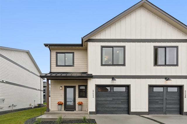view of front of home with a standing seam roof, an attached garage, concrete driveway, metal roof, and a front lawn
