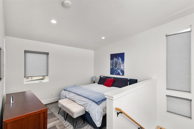 bedroom with wood finished floors, baseboards, and recessed lighting