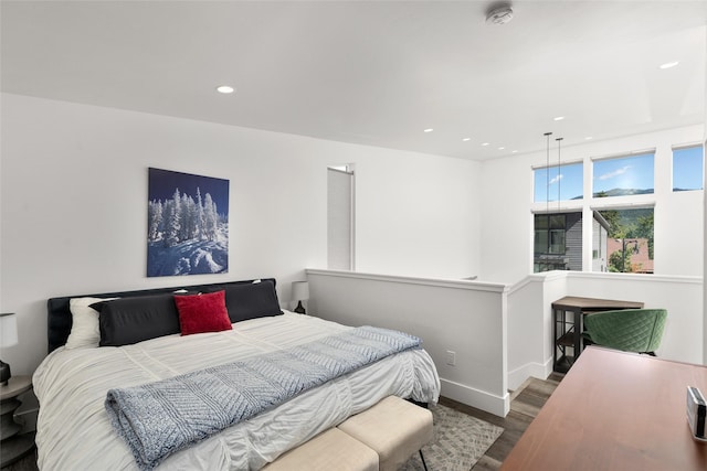 bedroom featuring wood finished floors, baseboards, and recessed lighting