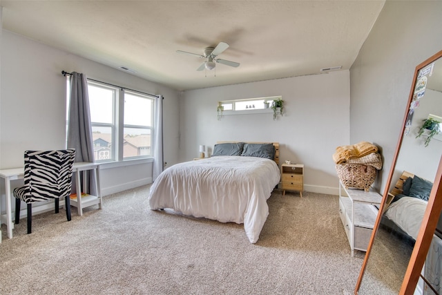 bedroom featuring multiple windows, carpet floors, baseboards, and a ceiling fan