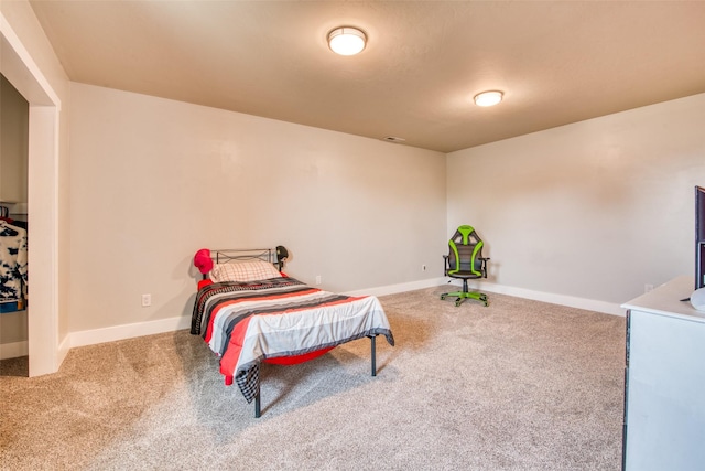 carpeted bedroom featuring baseboards