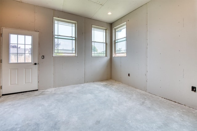 spare room featuring unfinished concrete flooring