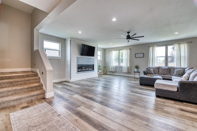 living area featuring baseboards, a ceiling fan, healthy amount of natural light, recessed lighting, and wood finished floors