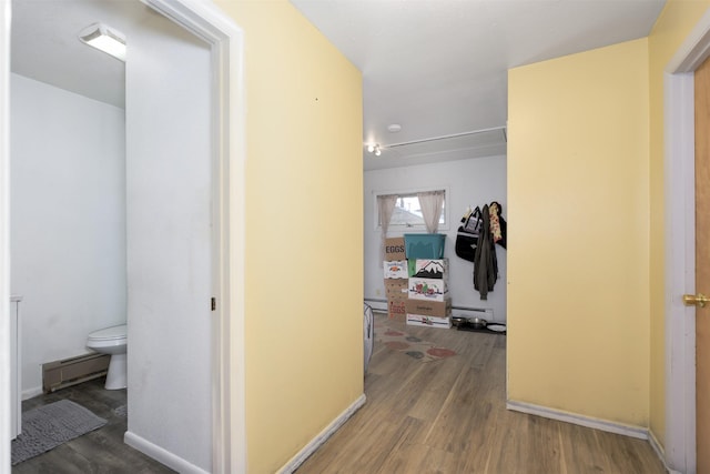 412 Spruce St, Anaconda, MT 59711 - hall with wood finished floors, a baseboard heating unit, and a baseboard radiator
