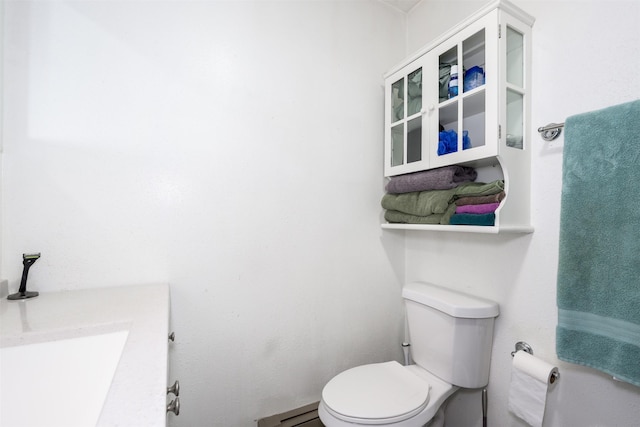412 Spruce St, Anaconda, MT 59711 - bathroom featuring toilet, baseboard heating, and vanity