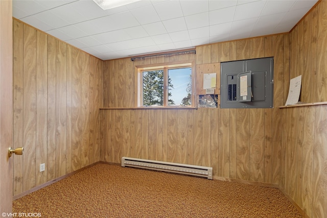 222 Lundeen Rd, Eureka, MT 59917 - unfurnished room featuring a baseboard radiator, electric panel, wooden walls, carpet, and baseboards