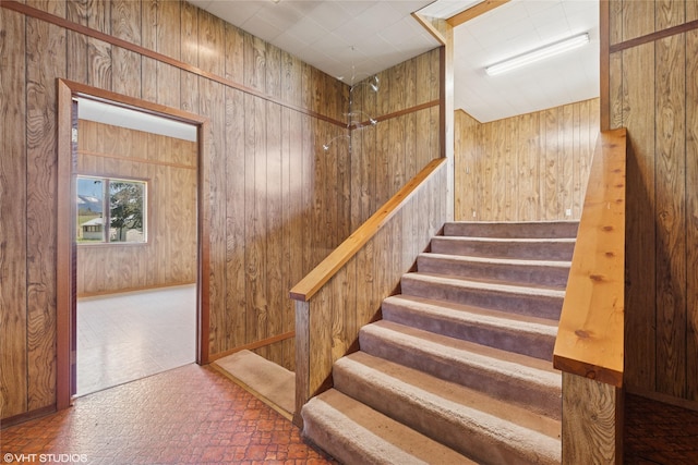 222 Lundeen Rd, Eureka, MT 59917 - staircase featuring brick patterned flooring and wood walls