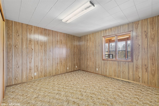 222 Lundeen Rd, Eureka, MT 59917 - empty room featuring carpet, wood walls, and baseboards