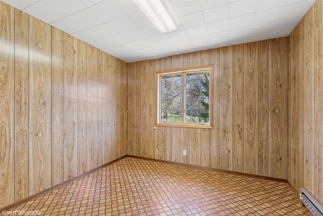 222 Lundeen Rd, Eureka, MT 59917 - unfurnished room with a baseboard heating unit and wooden walls