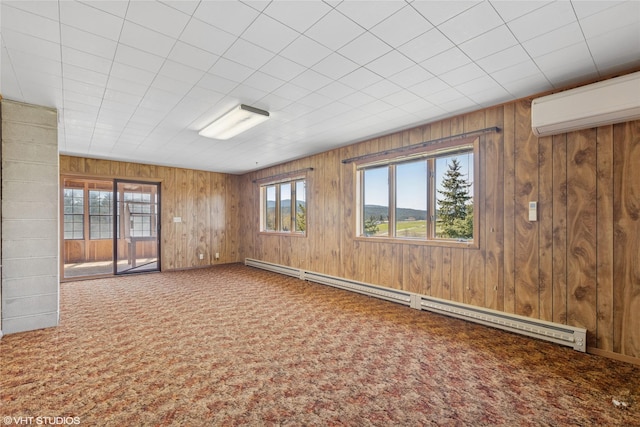 222 Lundeen Rd, Eureka, MT 59917 - empty room featuring a wall mounted air conditioner, carpet flooring, baseboard heating, wood walls, and baseboards