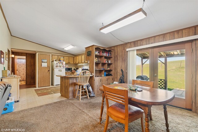 222 Lundeen Rd, Eureka, MT 59917 - dining space with vaulted ceiling, wooden walls, french doors, and light carpet