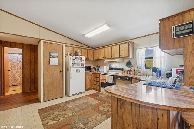 222 Lundeen Rd, Eureka, MT 59917 - kitchen with white appliances, lofted ceiling, a peninsula, brown cabinetry, and range hood