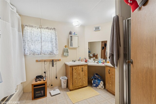 222 Lundeen Rd, Eureka, MT 59917 - full bath with a shower with door, vanity, and tile patterned floors