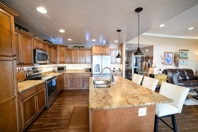 121 Choteau Ave NE, Great Falls, MT 59404 - kitchen with appliances with stainless steel finishes, a sink, a breakfast bar area, brown cabinetry, and crown molding