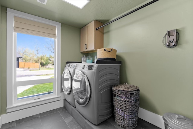 5519 Golf Dr, Lolo, MT 59847 - clothes washing area with separate washer and dryer, cabinet space, plenty of natural light, dark tile patterned flooring, and a textured ceiling