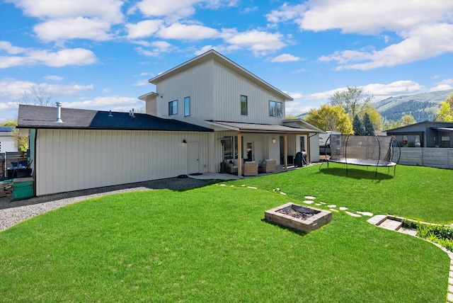 5519 Golf Dr, Lolo, MT 59847 - back of house with a trampoline, a patio area, and outdoor lounge area