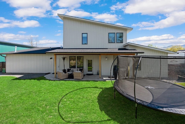 5519 Golf Dr, Lolo, MT 59847 - back of house with a trampoline, outdoor lounge area, a yard, and a patio area