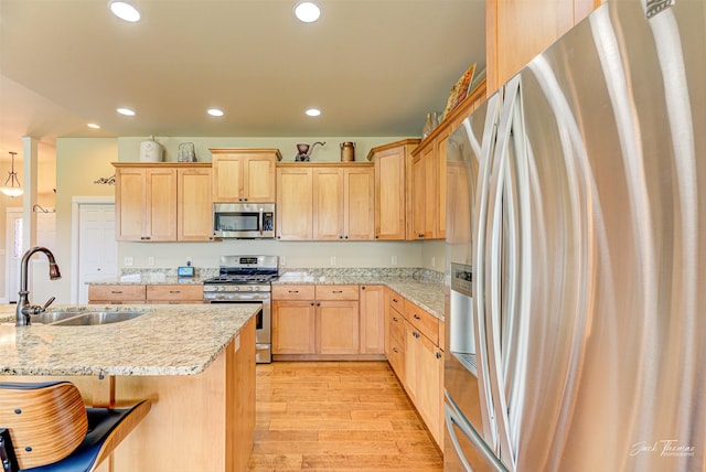 7175 Bootlegger Dr, Helena, MT 59602 - kitchen with stainless steel appliances, a sink, light brown cabinets, light wood-style floors, and recessed lighting