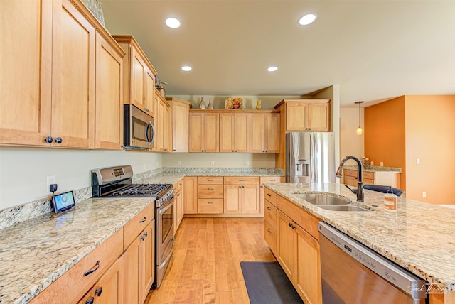 7175 Bootlegger Dr, Helena, MT 59602 - kitchen featuring stainless steel appliances, light brown cabinetry, a sink, light wood-type flooring, and recessed lighting