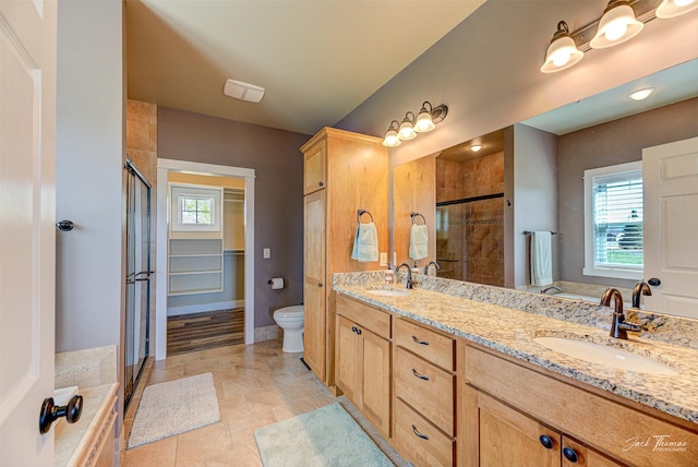 7175 Bootlegger Dr, Helena, MT 59602 - full bathroom with a shower stall, double vanity, toilet, and baseboards