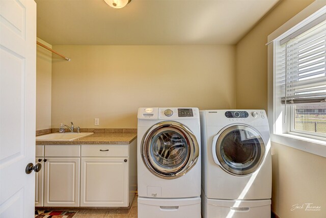 7175 Bootlegger Dr, Helena, MT 59602 - clothes washing area featuring washing machine and clothes dryer and cabinet space