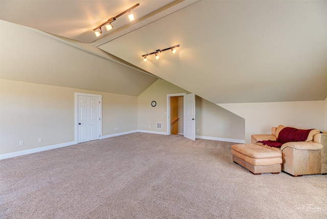 7175 Bootlegger Dr, Helena, MT 59602 - unfurnished room with rail lighting, baseboards, light colored carpet, and lofted ceiling
